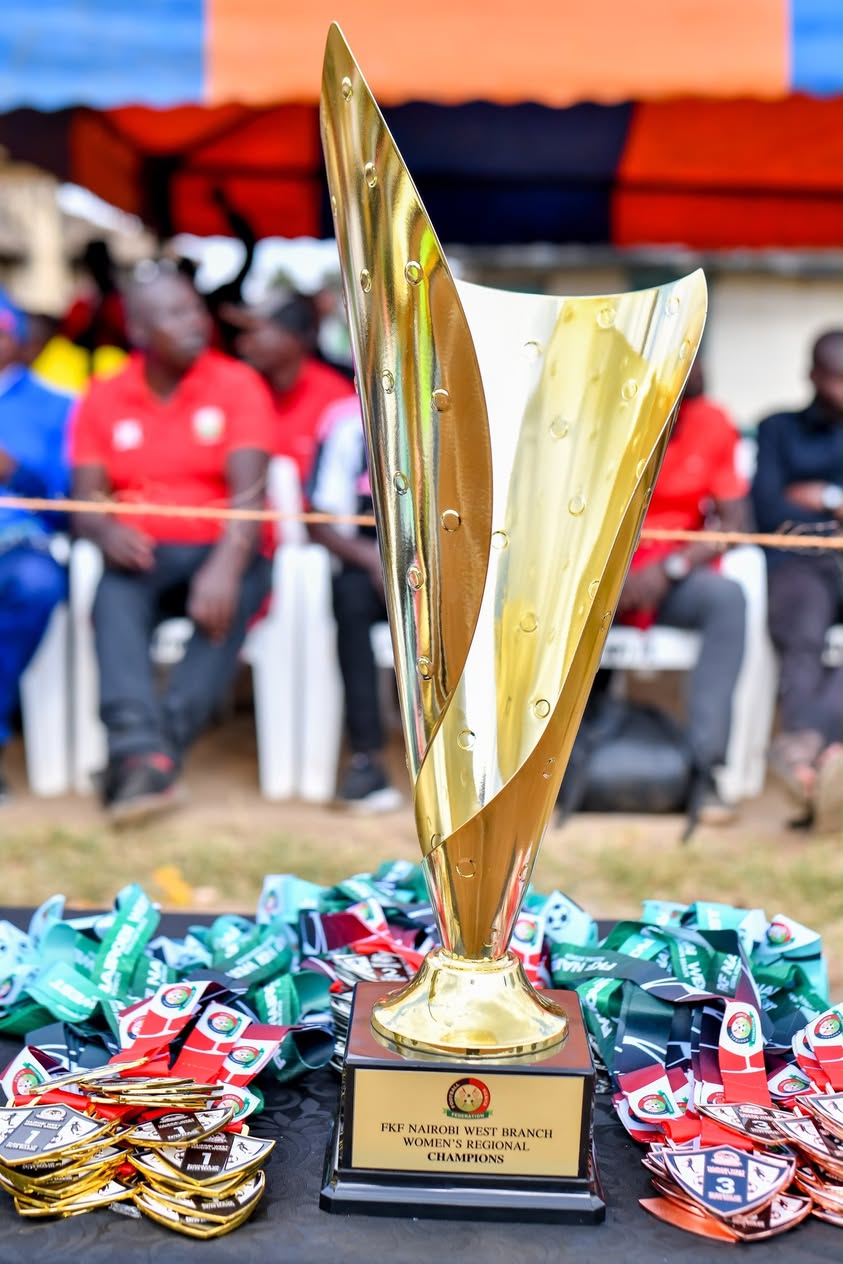 The FKF Nairobi West Branch women's regional champions trophy, surrounded by medals