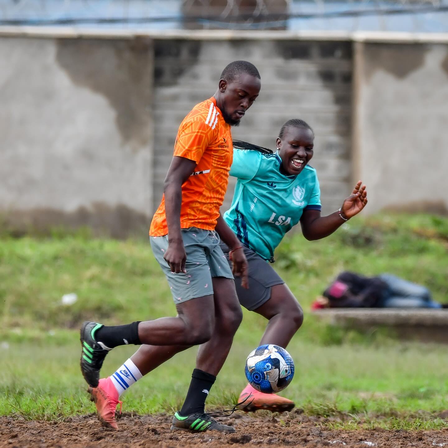 Two Nairobi West players contesting the ball on a branch league pitch